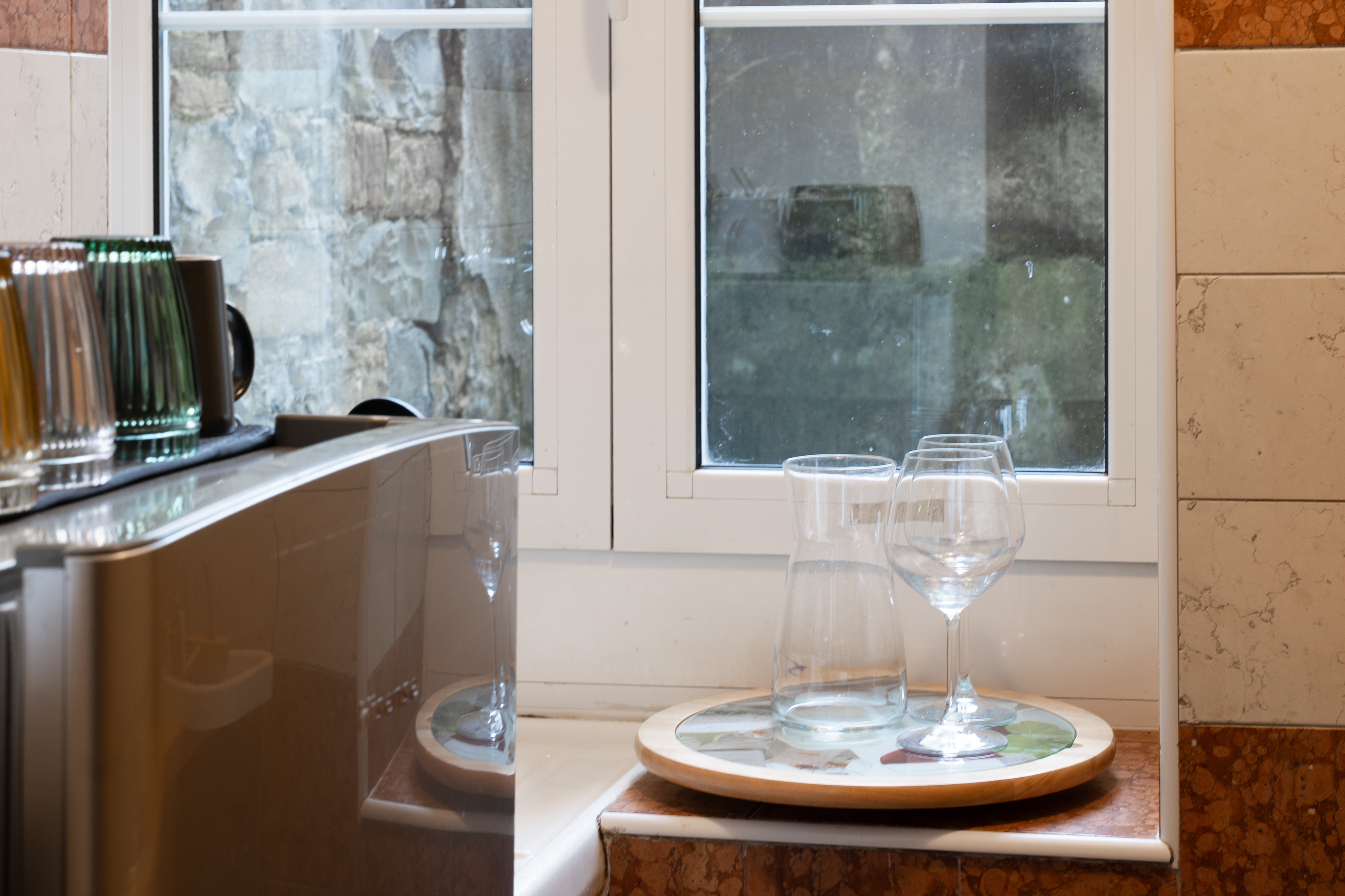 Elegant small kitchen, made to appear larger and welcoming by expert lighting