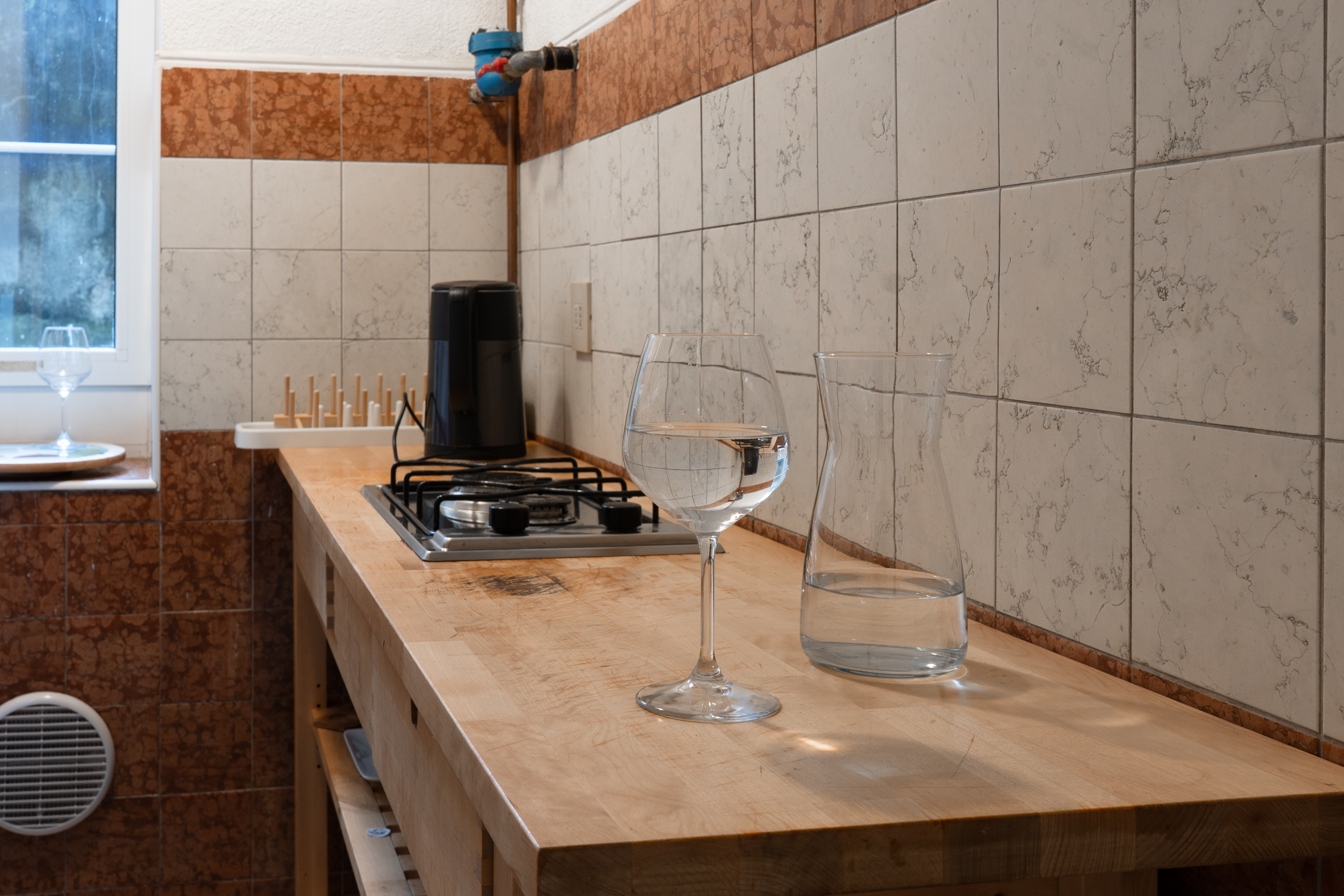 Elegant small kitchen, made to appear larger and welcoming by expert lighting