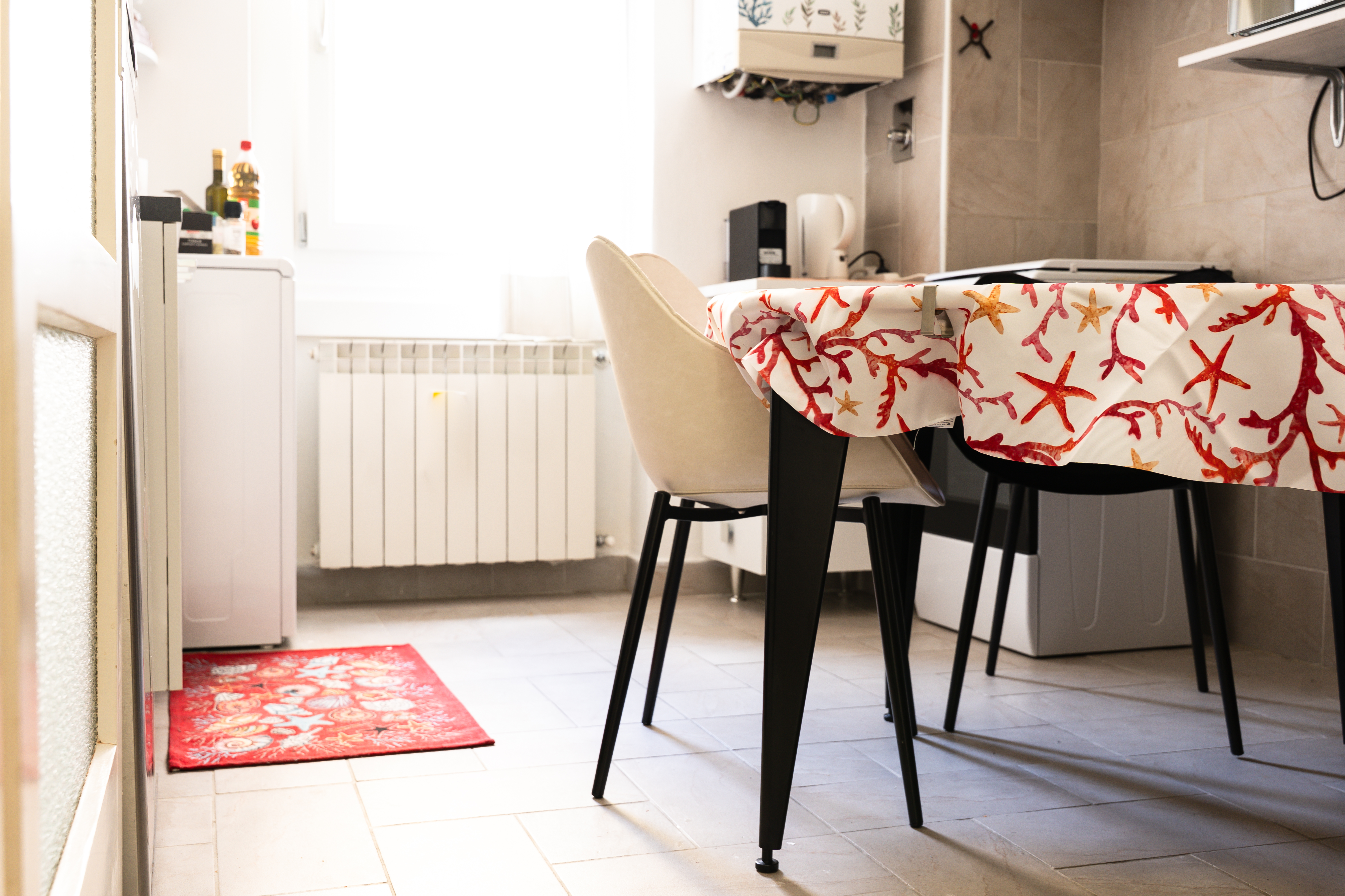 Elegant small kitchen, made to appear larger and welcoming by expert lighting